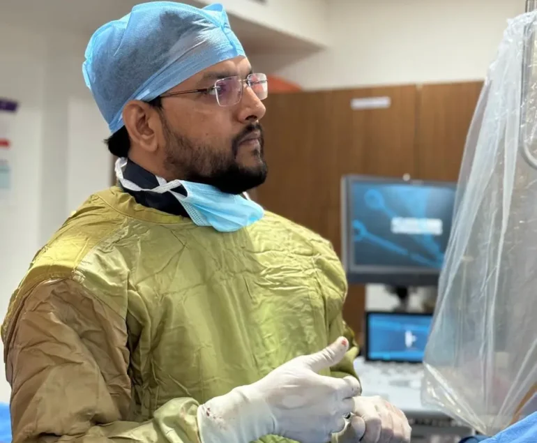 Interventional Radiologist Dr. Rakesh Kumawat inside operation theatre preparing for varicocele embolization treatment in Jaipur, Rajasthan.